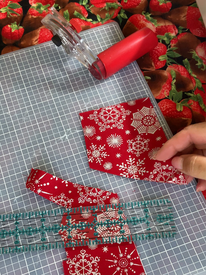 crumb pieces of fabric from the same material sitting on a cutting table a rotary cutter nearby