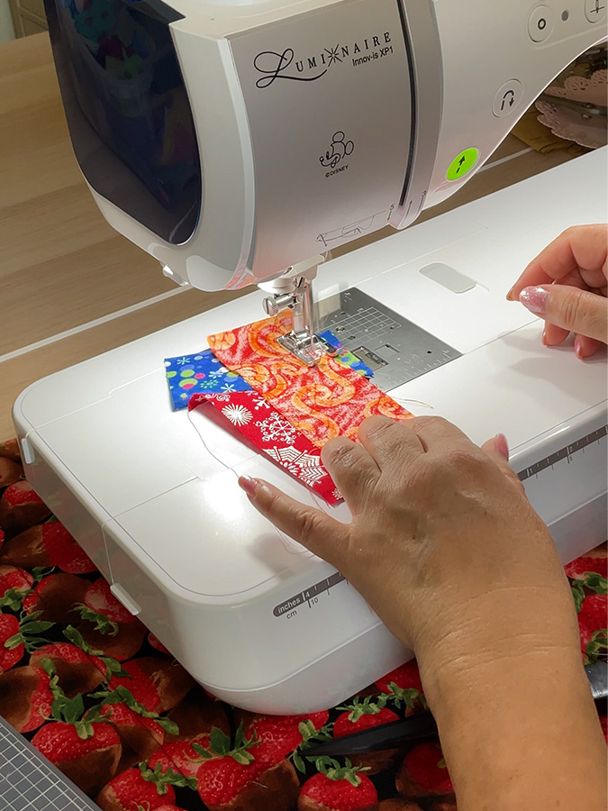 stitching the third crumb piece of fabric to the fragment already put together previously