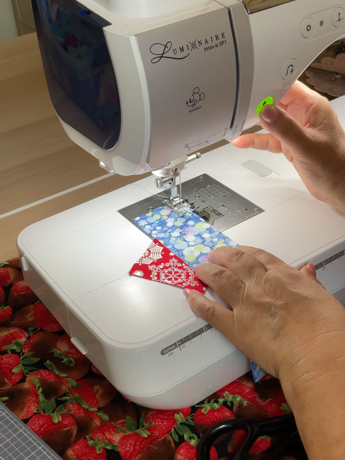 two crumb pieces of fabric being stitched on a sewing machine