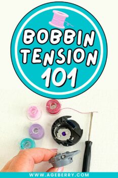 Learn how bobbin tension works with a clear, beginner-friendly sewing lesson from Ageberry.com. Image shows a close-up of a sewing machine bobbin case held in hand, a small screwdriver used for bobbin tension adjustment, and several colorful plastic bobbins on white fabric. The graphic text “Bobbin Tension 101” highlights this sewing tutorial focused on bobbin thread tension, common bobbin tension problems, and how to set bobbin tension correctly for balanced stitches.