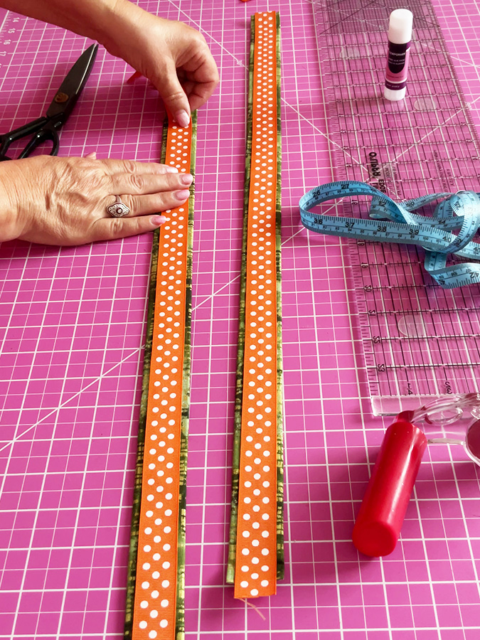 adding a ribbon to the handle of the bag preparing the ribbon pieces