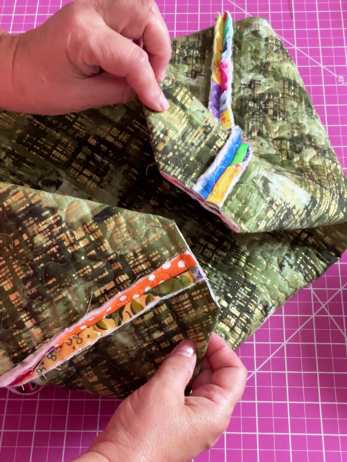 the corners of the future bag after the proper seam is done and the extra material is cut. the bag is still inside out