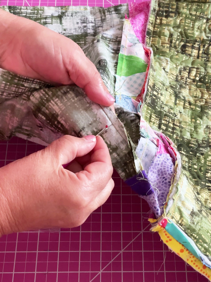 using the seam ripper to make an opening in the lining of the bag to allow for final turning right side out