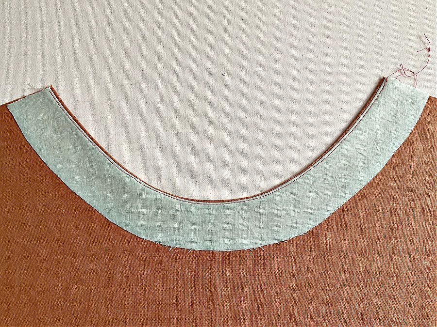 The piece of material shown from the wrong side with the understitching visible