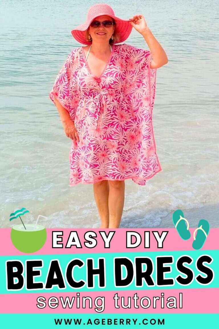 Learn how to make an easy DIY beach dress with this beginner-friendly sewing tutorial. Image shows a woman standing at the shoreline, wearing a loose pink-and-white beach dress with a V-neck, wide sleeves, and relaxed fit, paired with a pink sun hat. The simple shape and lightweight fabric make this an ideal no-pattern sewing project for summer cover-ups and vacation wear, from Ageberry.com.