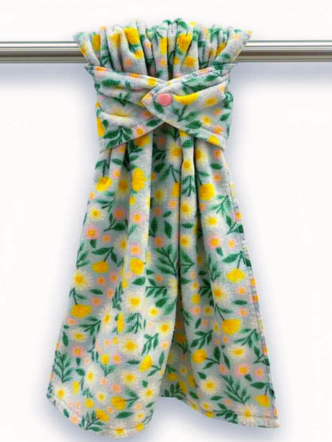 a multi colored towel using a plastic snap shown hanging on a bar