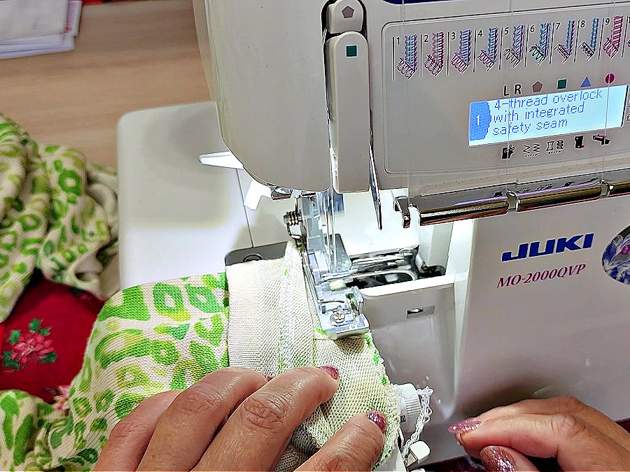 a woman sewing the sleeve on a Juki MO-2000QVP serger overlocker
