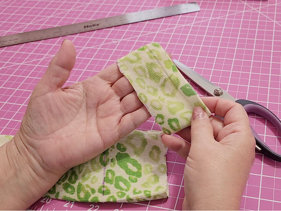 a womans hands showing the band cut from the sleeve which includes the original finish of the sleeve