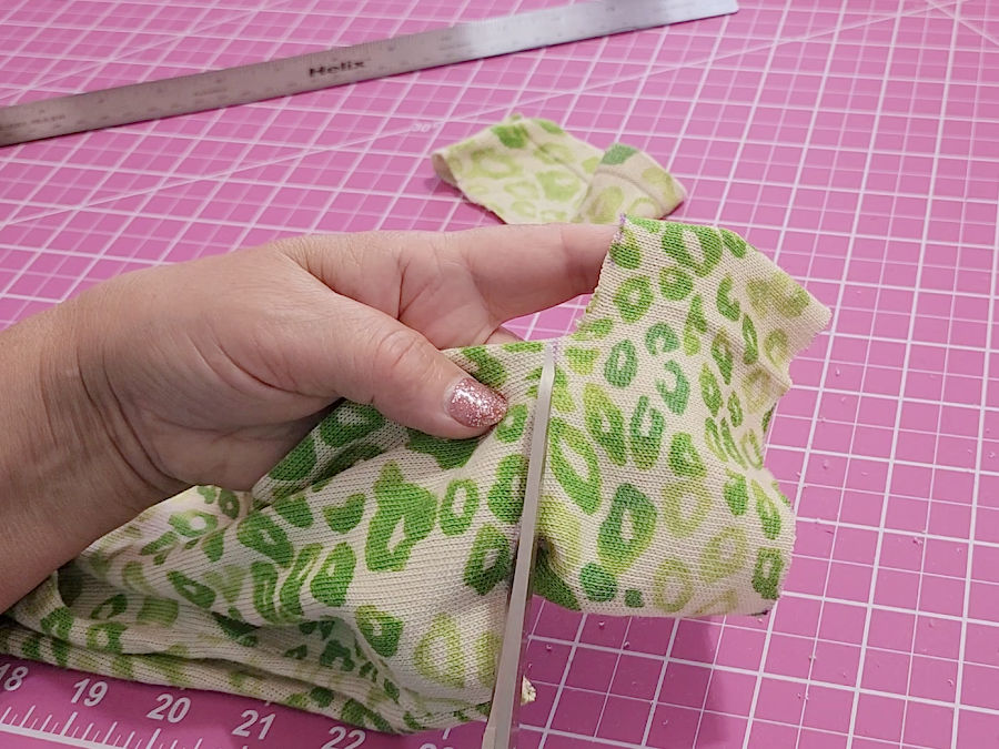 image shows a p[air of scissors while making the second cut to shorten the sleeve