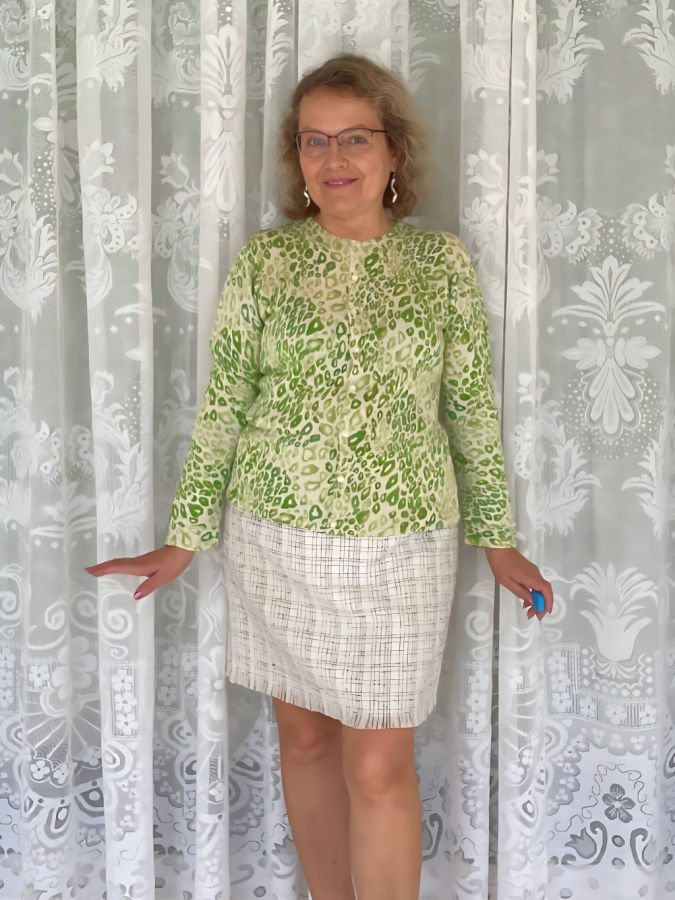 a woman wearing the cardigan with shortened sleeves