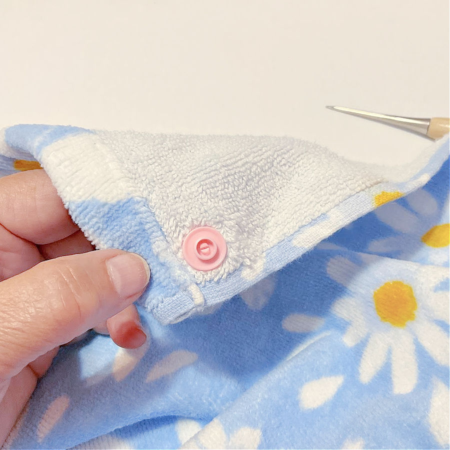 the stud part of the snap shown installed on the cap previously inserted