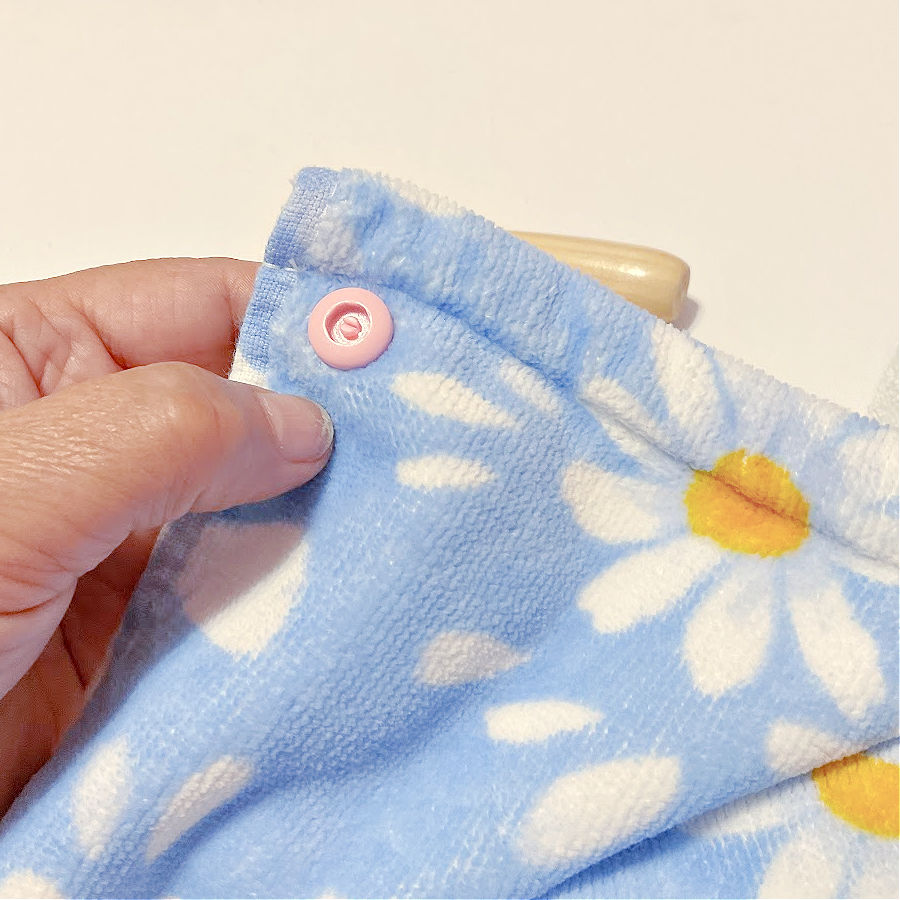 the socket part of the snap shown installed on the stud previously inserted