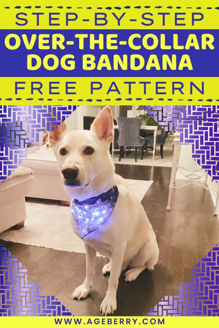 Learn how to sew a step-by-step over-the-collar dog bandana with a free pattern. Image shows a light-colored dog sitting indoors, wearing a blue patterned bandana that slides over the collar, with small LED lights glowing through the fabric. The bandana fits neatly around the dog’s neck without ties, showing a practical, beginner-friendly sewing project for pets, from Ageberry.com.