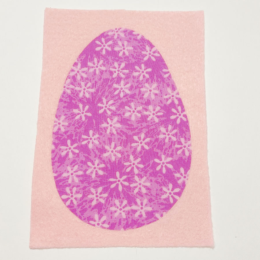 the face of the easter egg fused to the piece of soft felt which will be the backing