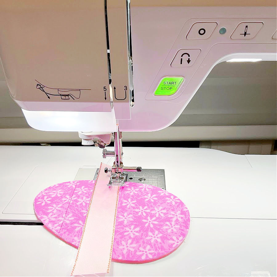 a sewing machine needle assembly while sewing the center ribbon to the easter egg face