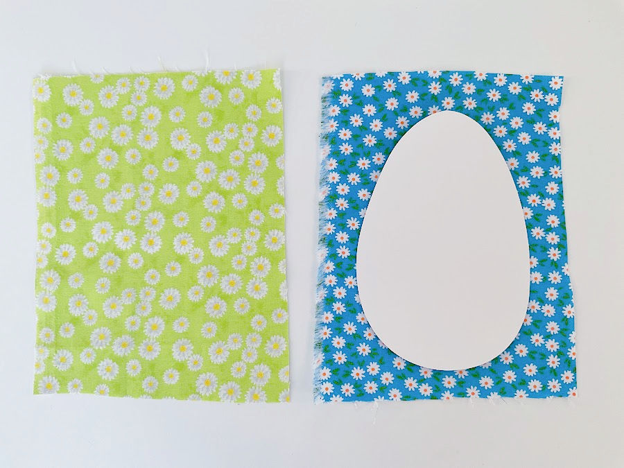 rectangles of material cut a little larger than the egg shape the egg pattern sitting on one rectangle for comparison