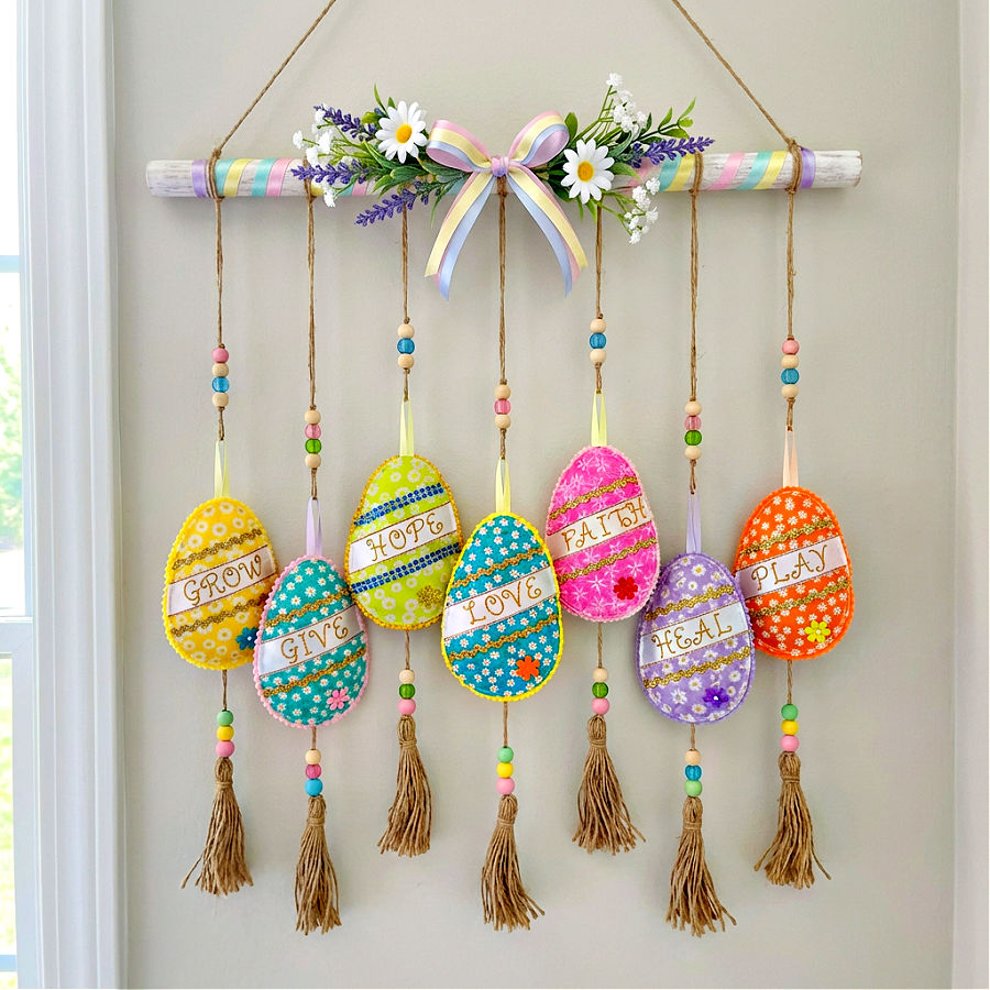 wall hanging ornament made with 7 fabric easter eggs the words on them are grow give hope love faith heal play
