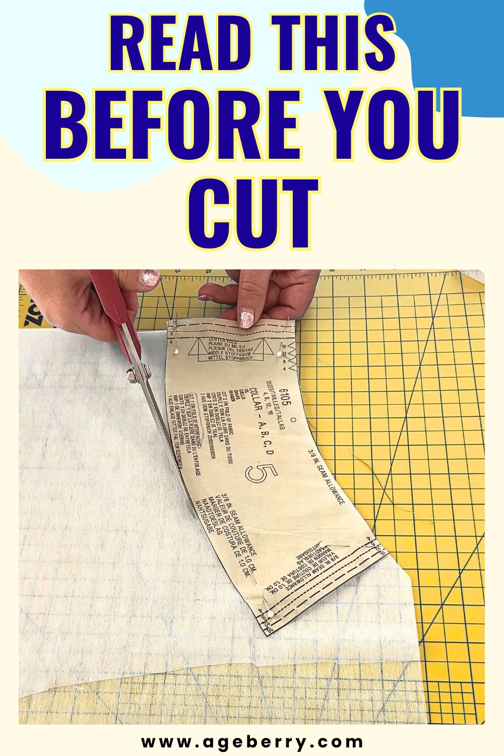 Large bold purple and yellow text reading “READ THIS BEFORE YOU CUT” above a close-up of hands cutting white fusible interfacing with red-handled scissors. A paper sewing pattern piece is pinned on top of the interfacing and positioned on a yellow grid cutting mat. The website www.ageberry.com appears at the bottom