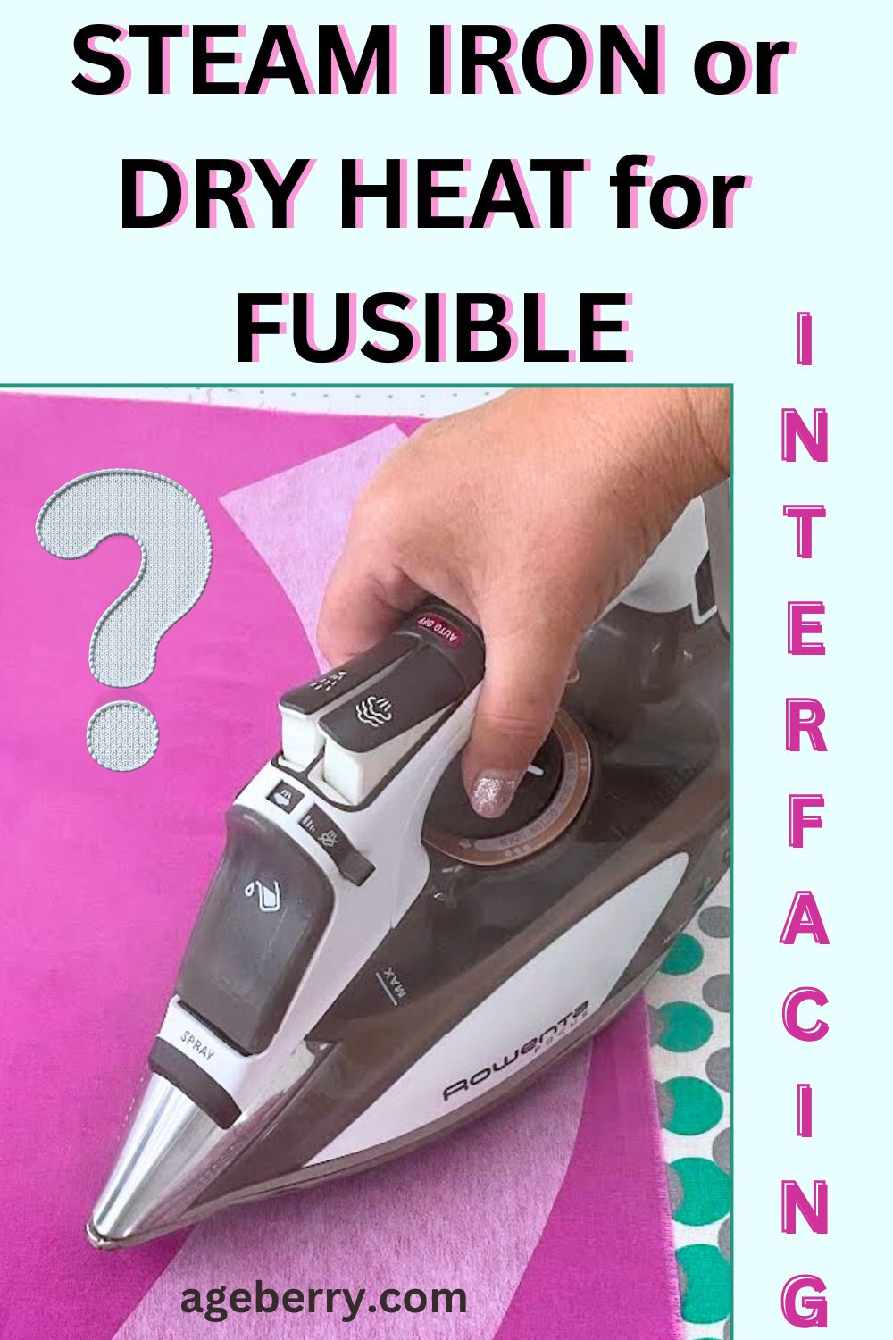 Close-up of a steam iron pressing pink fabric with a piece of white fusible interfacing underneath. A hand is adjusting the steam setting on the iron. The background shows a bright pink ironing surface and a question mark graphic beside the iron. Large text at the top reads “Steam Iron or Dry Heat for Fusible Interfacing,” with the word “Interfacing” placed vertically along the side