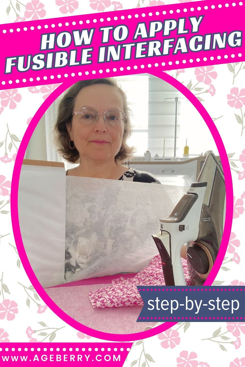Woman in a sewing room holding a large piece of white fusible interfacing. An iron sits on a pink ironing surface in front of her, with pink floral fabric underneath the interfacing. The image has a bright pink frame and floral background, with large text at the top reading “How to Apply Fusible Interfacing” and a small banner that says “step-by-step,” plus the website ageberry.com at the bottom