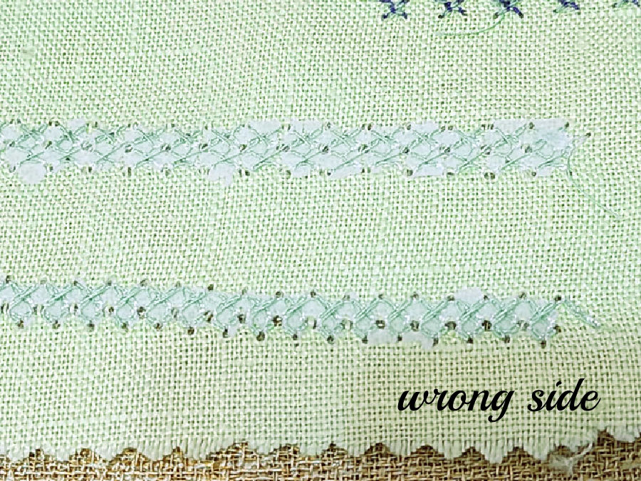 two rows of decorative stitching backed by stabilizer which has been partially removed parts are still visible between stitches