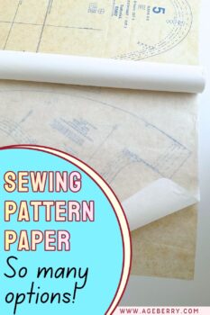 A roll of tracing paper laid over a printed sewing pattern, showing how transparent paper can be used to copy and preserve pattern pieces. The overlay text reads “Sewing Pattern Paper – So many options!” making it clear that the pin is about different types of paper used in sewing for tracing, drafting, and storing patterns.