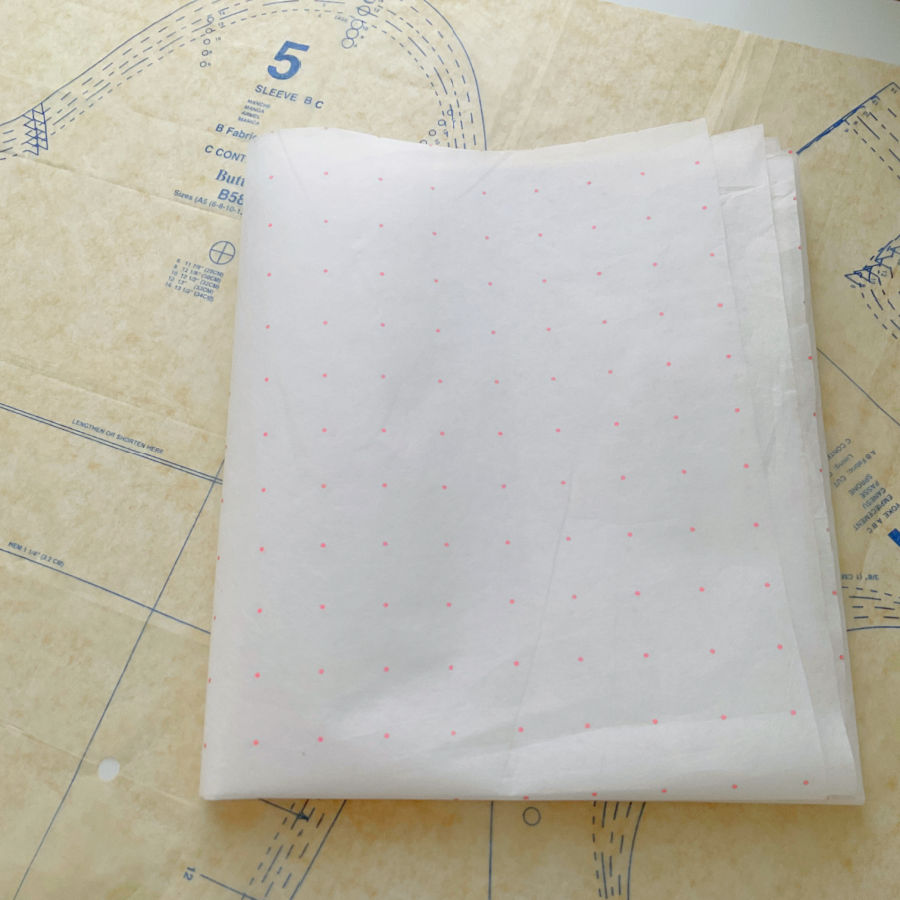 dotted paper used for drafting patterns sitting on top of a pattern