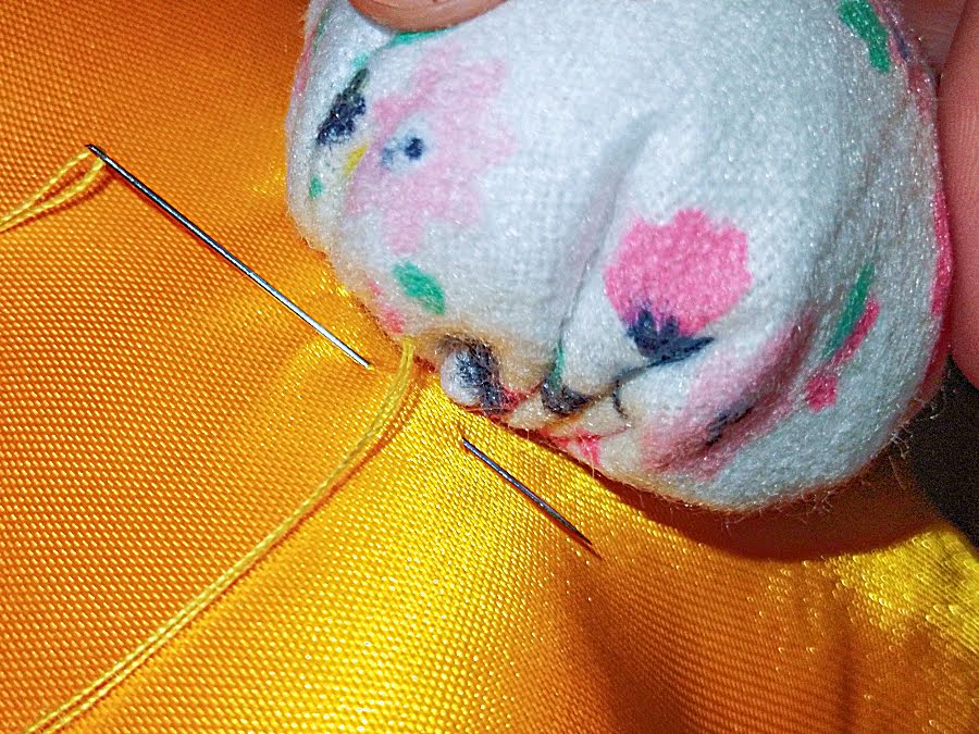 Close-up view of hand stitches hidden inside the gathered tail edge while attaching it firmly to the bunny’s back.