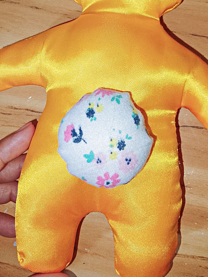 Finished bunny back with the fabric tail securely sewn in place, sitting snugly against the body.