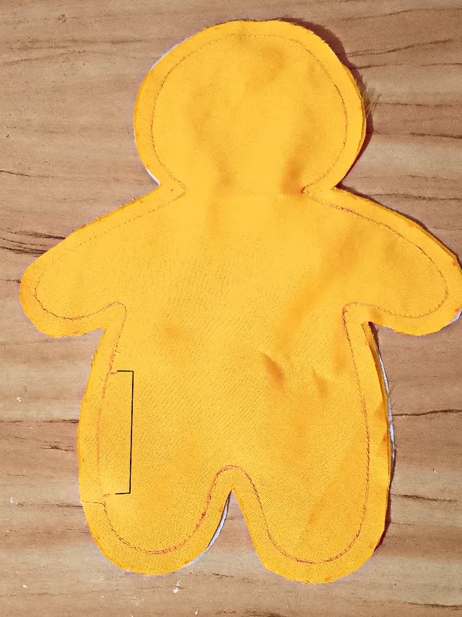Soft toy body after stitching along the traced outline, with smooth seams around the shape and a clearly visible unsewn section left open for turning and stuffing.