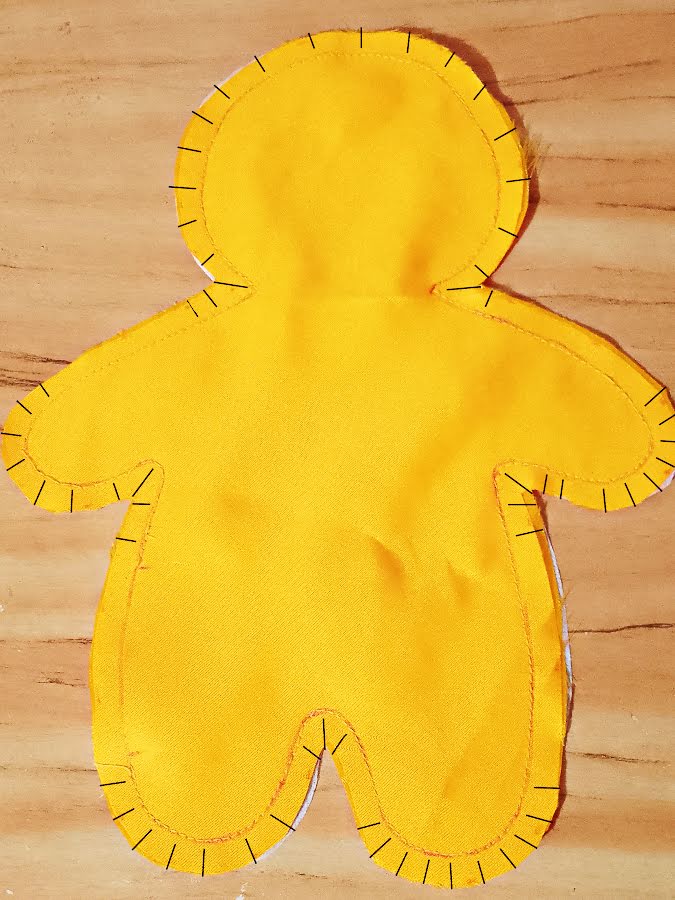 Soft toy body with seam allowances trimmed and clipped around curved areas and corners, showing evenly spaced notches that allow the fabric to spread smoothly when turned.