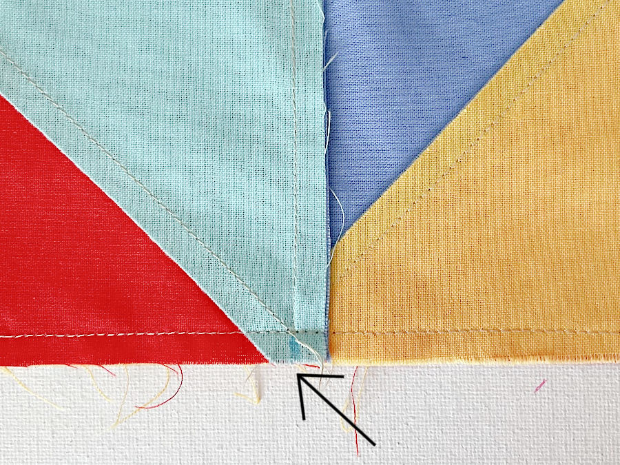 arrow shows where a couple of stitches are removed on the other side in preparation for reducing the bulk in the center