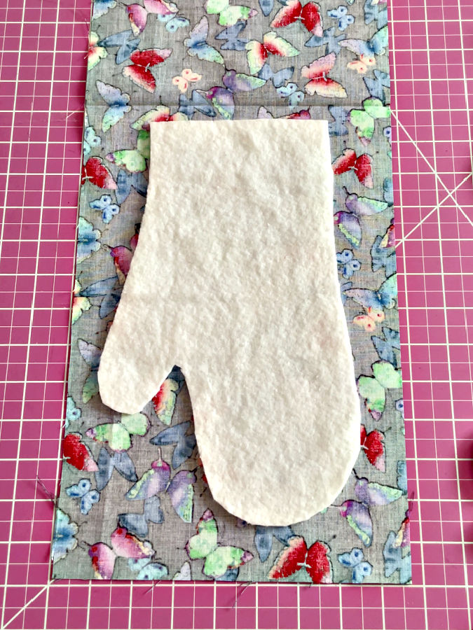 arranging the batting on the fabric for the oven mitt