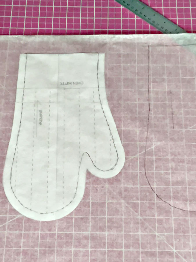 Paper pattern piece shown with the seam allowance marked to allow tracing of both shapes with ans without the seam allowance