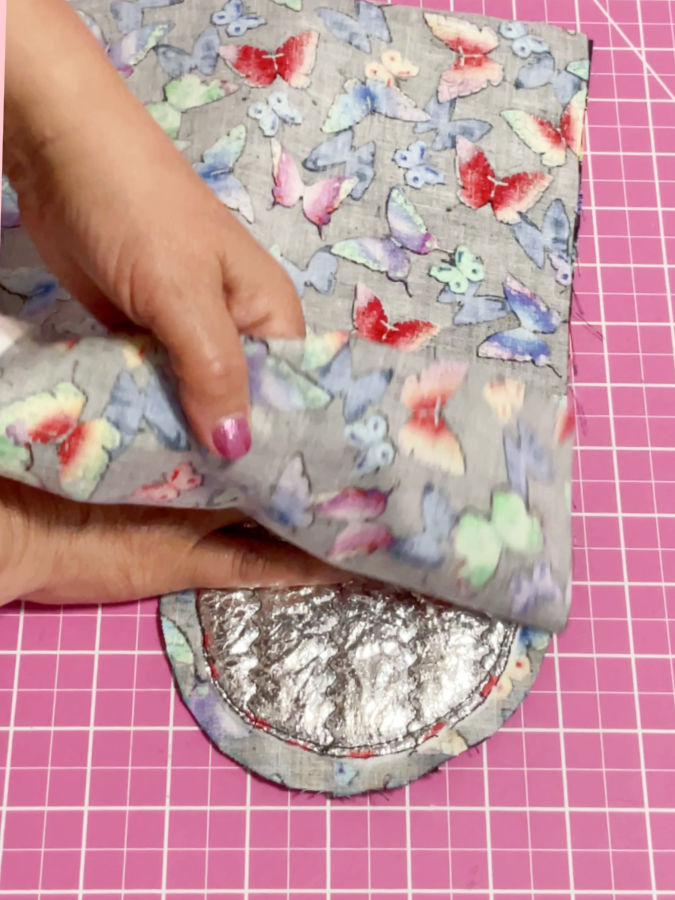 smoothing the lining over the mitt before final assembly