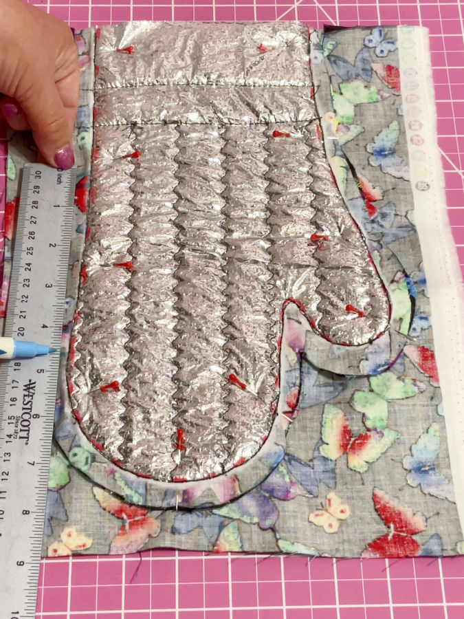 a womans hand holding a ruler showing the 4 1/2 inches opening that needs to be left in the final seam