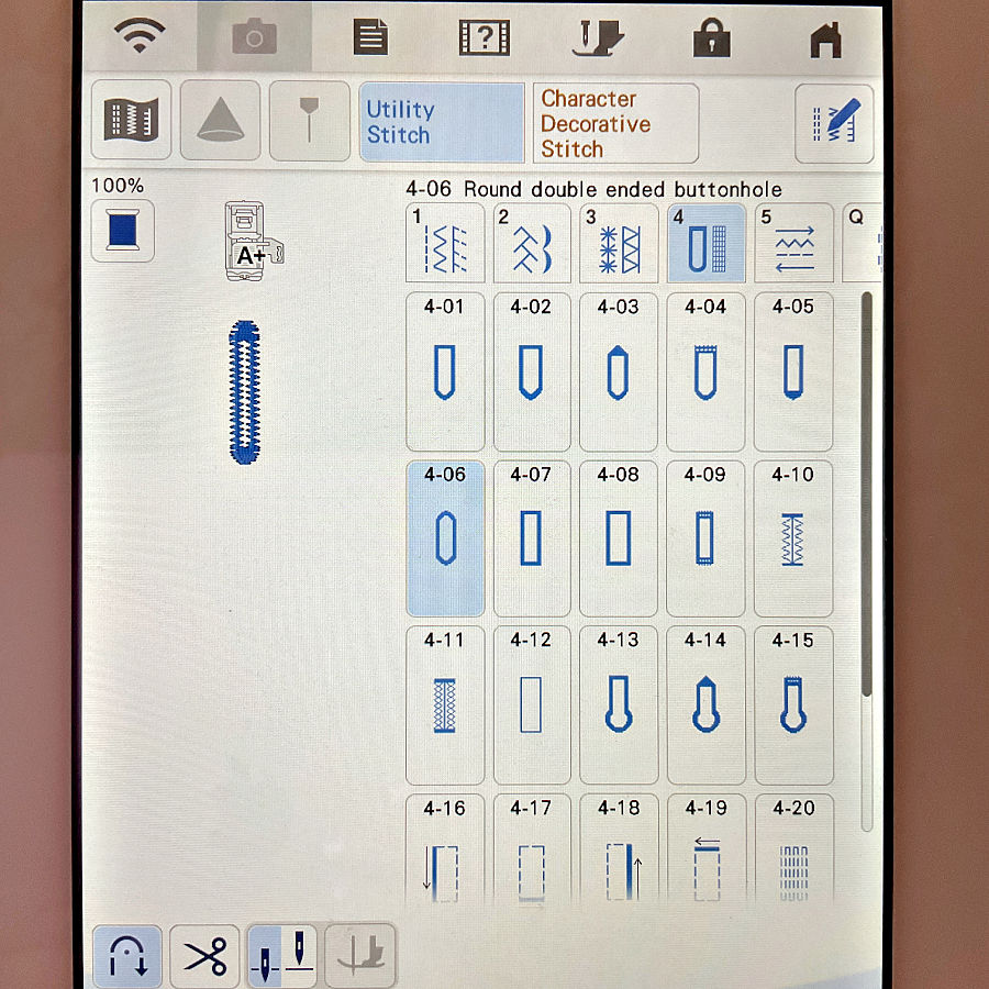 Machine display with utility stitch menu open and the round double-ended buttonhole option selected.