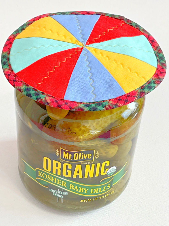 the jar opener is finished and lies on top of a pickle jar