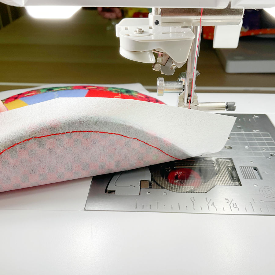 placing a piece of stabilizer under the material to allow it to glide on the sewing machine while sewing