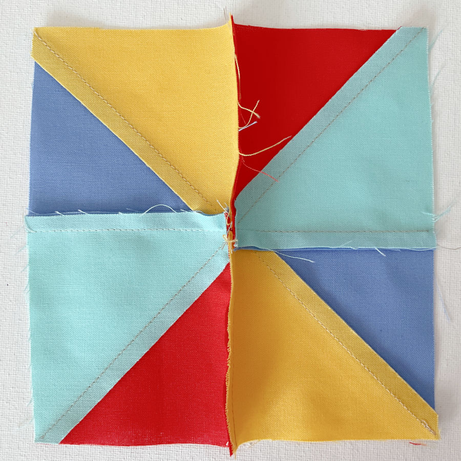 after sewing the two parts the points meet in the middle showing the pinwheel this is seen from the wrong side