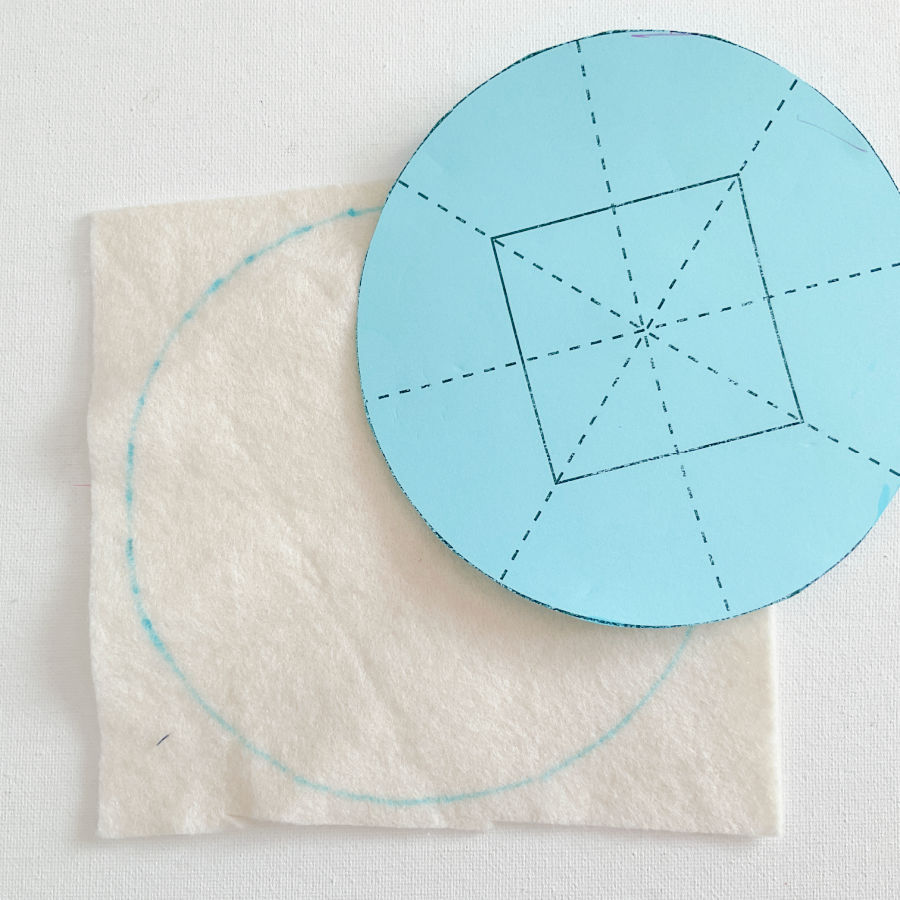 the circular template being used to cut a circle from the cotton batting