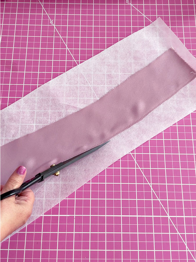 trimming the stabilizer along the stitch to match the seam allowance just stitched