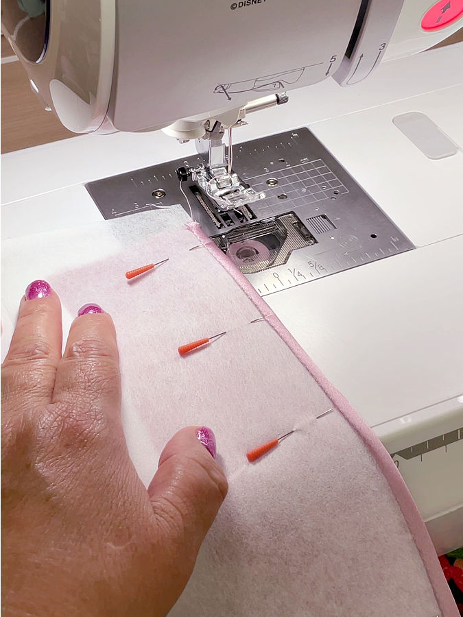 starting stitching the actual hem close to the edge of the fabric