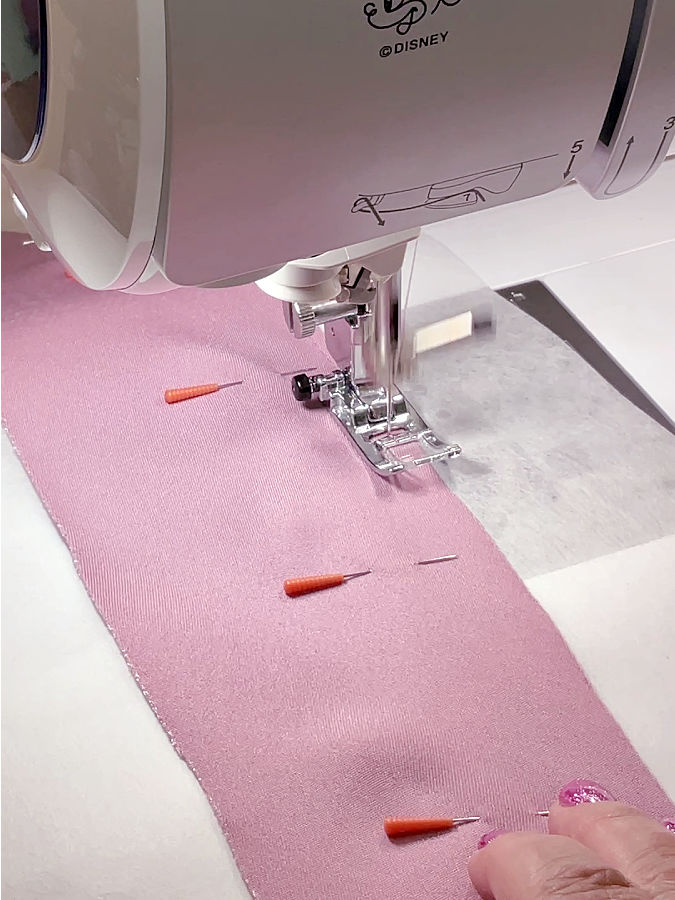 sewing machine needle assembly shown while stiotching the material to the stabilizer