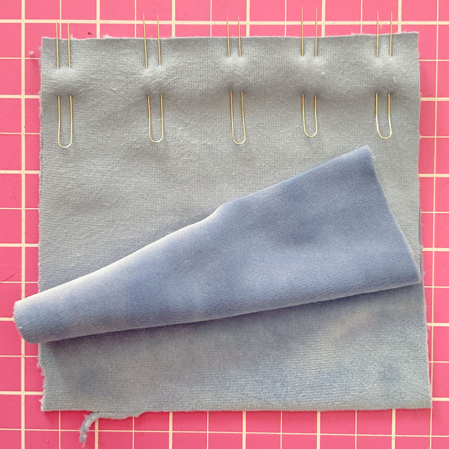 five fork pins used to hold together two pieces of velvet