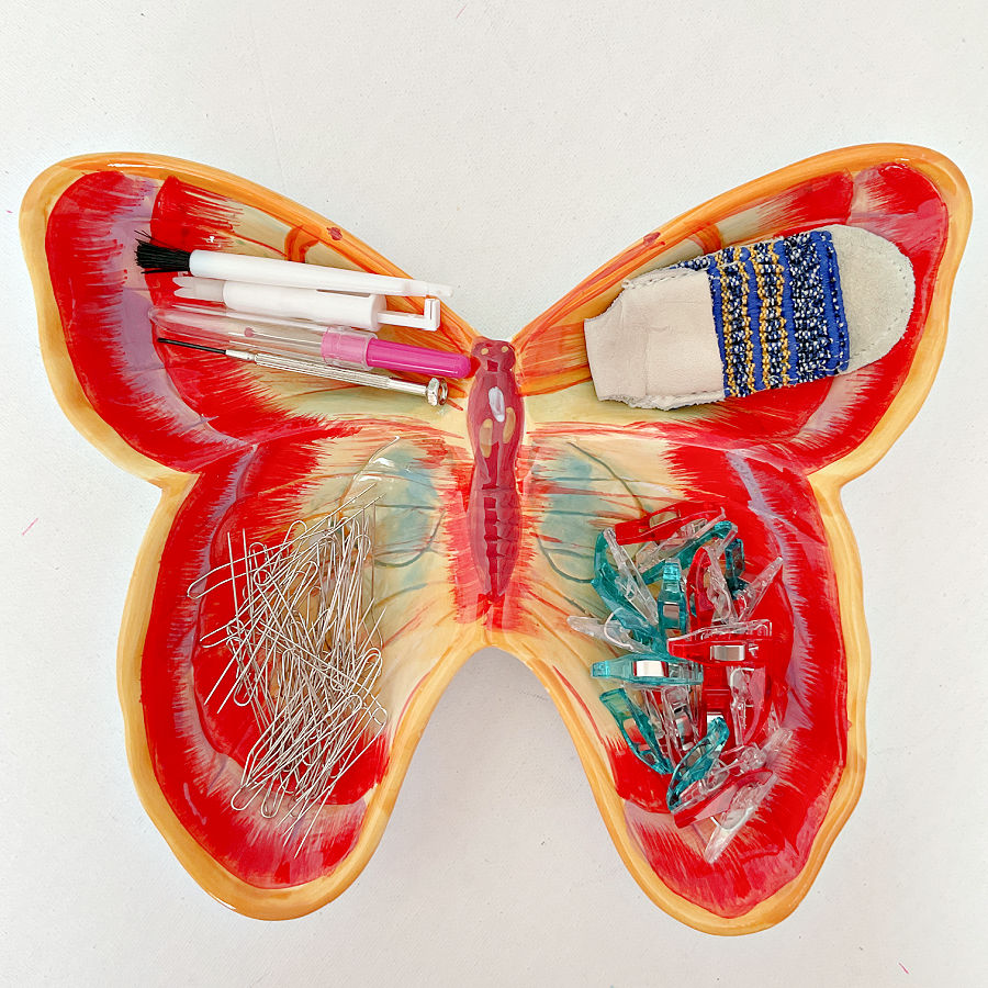 ceramic butterfly dish used to hold fork pins and other sewing tools