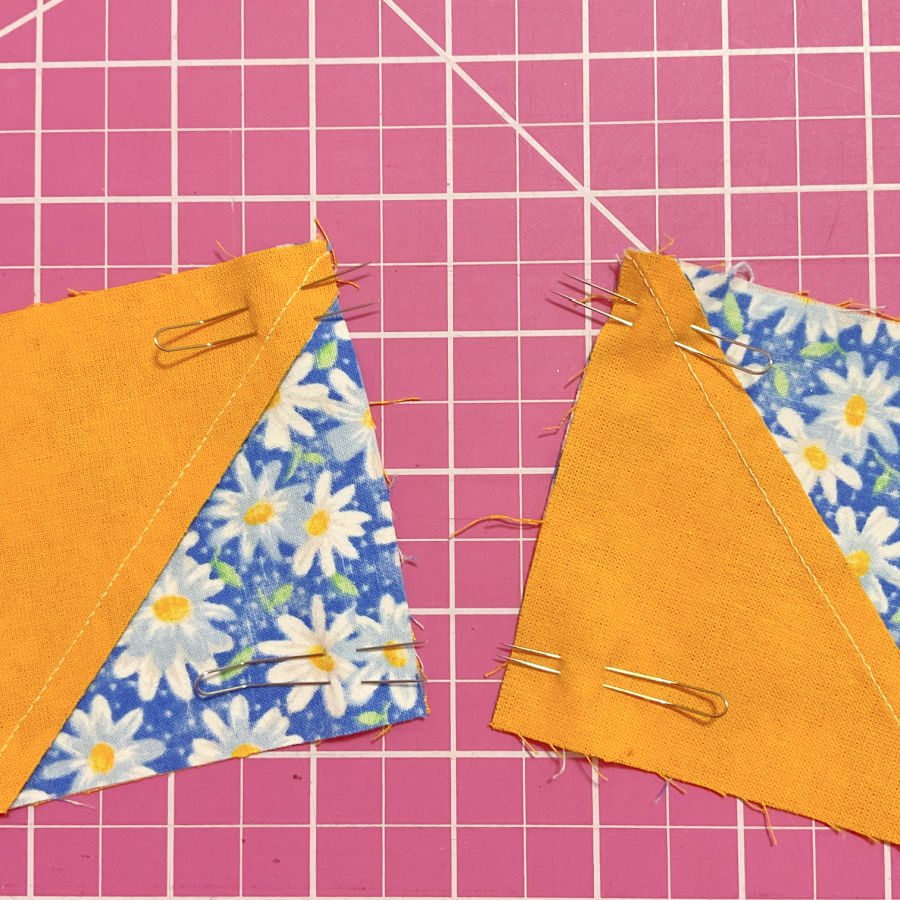 two pairs of half square triangles pinned using fork pins waiting to be sewn