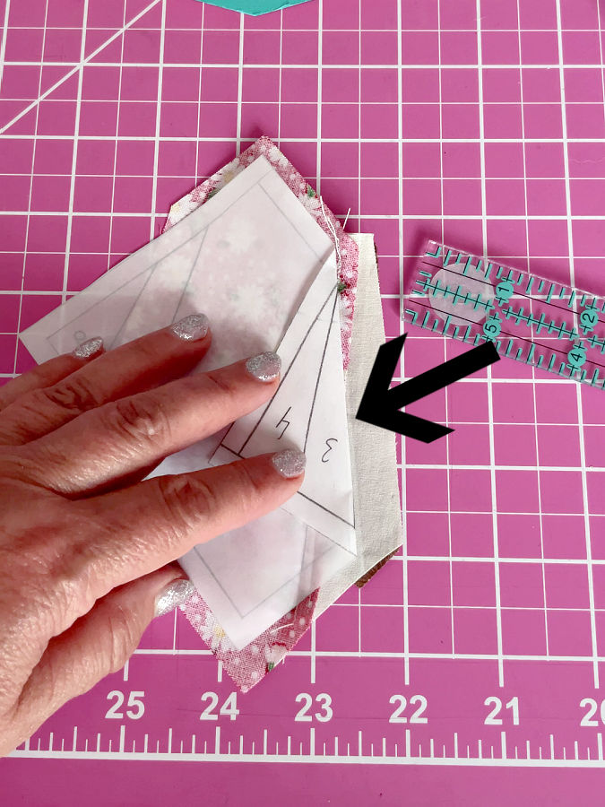 folding the paper between pieces 2 and 3