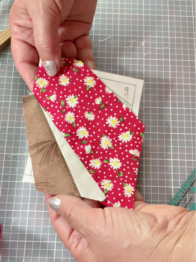 fabric piece opened after the seam is pressed using a finger presser after sewing piece 3