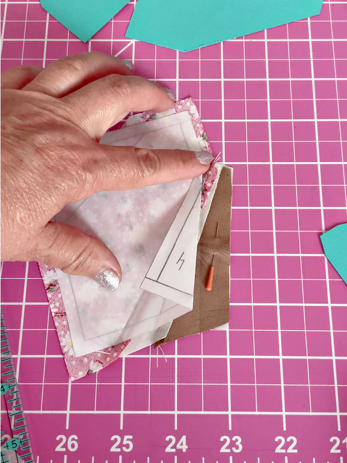 a womans hand showing the paper fold between pieces 3 and 4